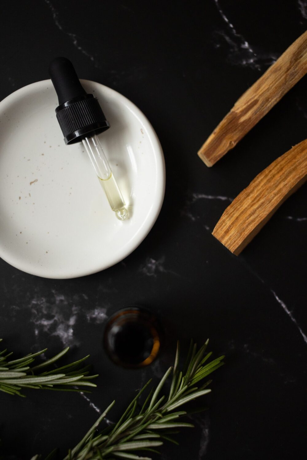 essential oil, herbs, and palo santo