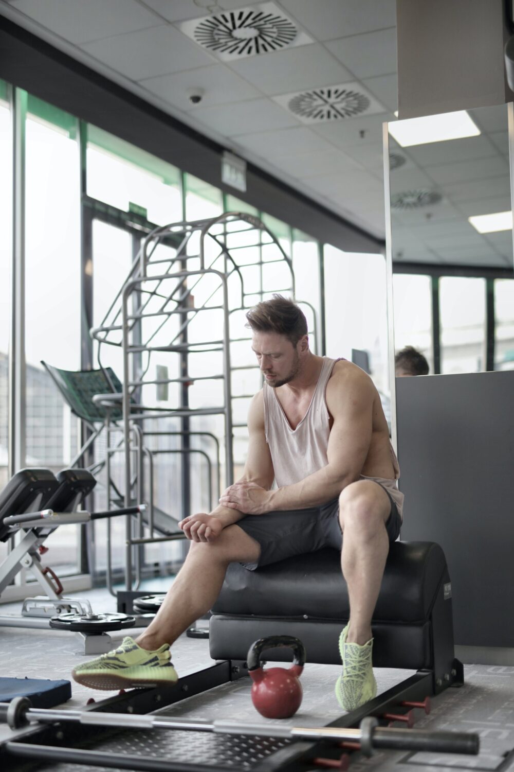 a man holding his sore arm after working out